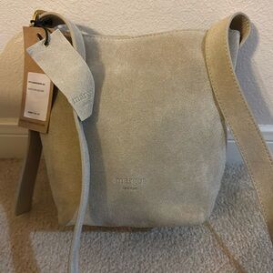 NWT Margot suede Kaye mini bucket bag with adjustable shoulder strap.